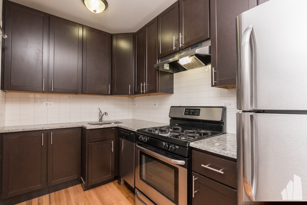 Studio apartment features hardwood floors, large living space.